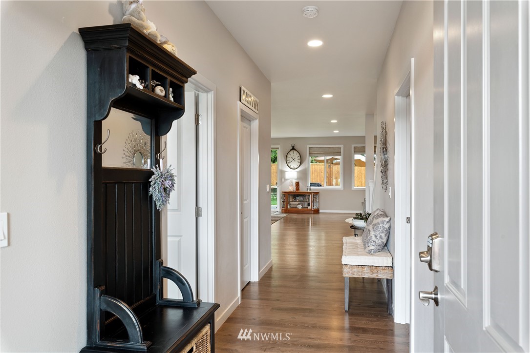 320 Blue Glacier Loop Sequim, WA 98382 - Photo 3 of 38 a view of a hallway view with wooden floor and living room