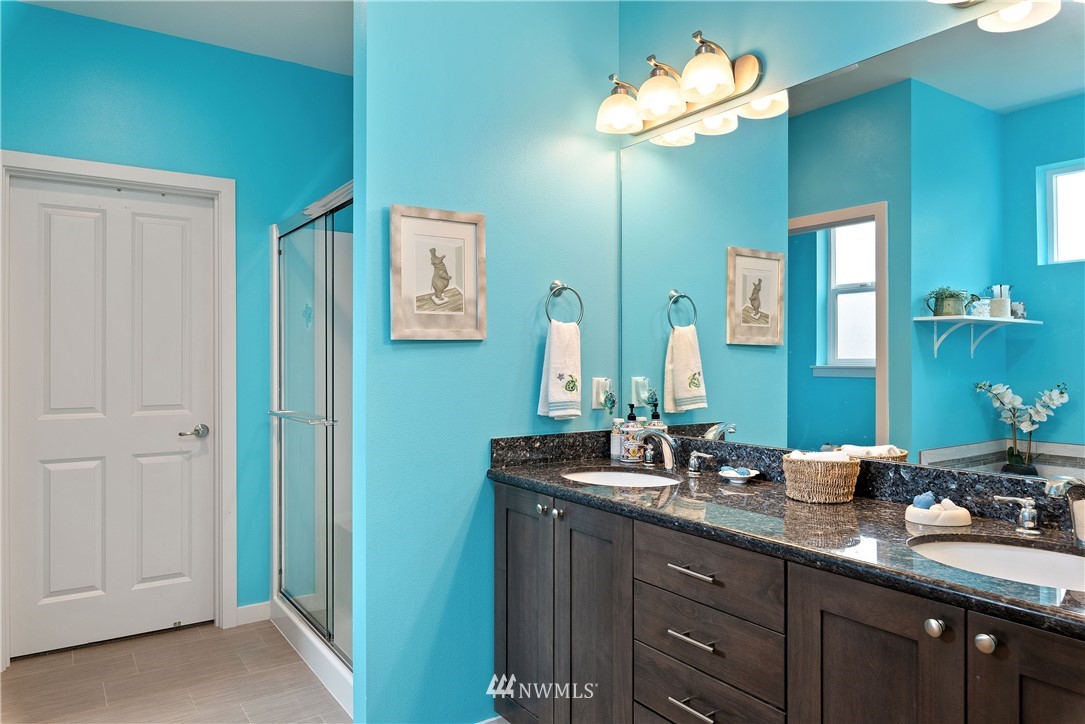 320 Blue Glacier Loop Sequim, WA 98382 - Photo 21 of 38 a bathroom with a double vanity sink and a mirror