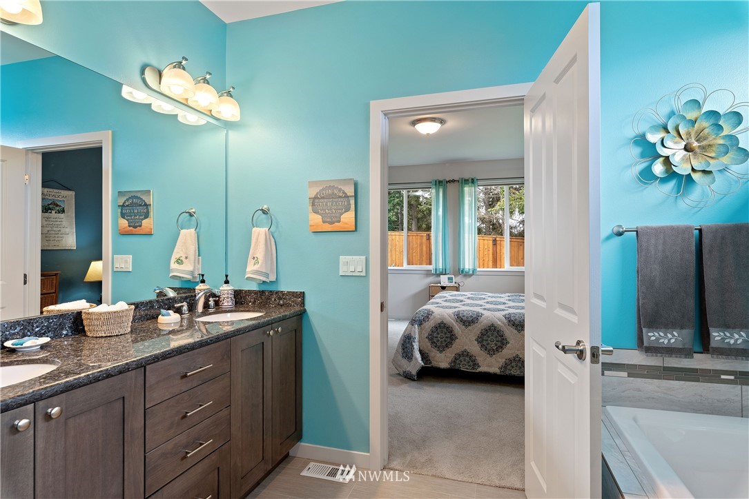 320 Blue Glacier Loop Sequim, WA 98382 - Photo 22 of 38 a en suite bathroom with a double vanity sink and a mirror