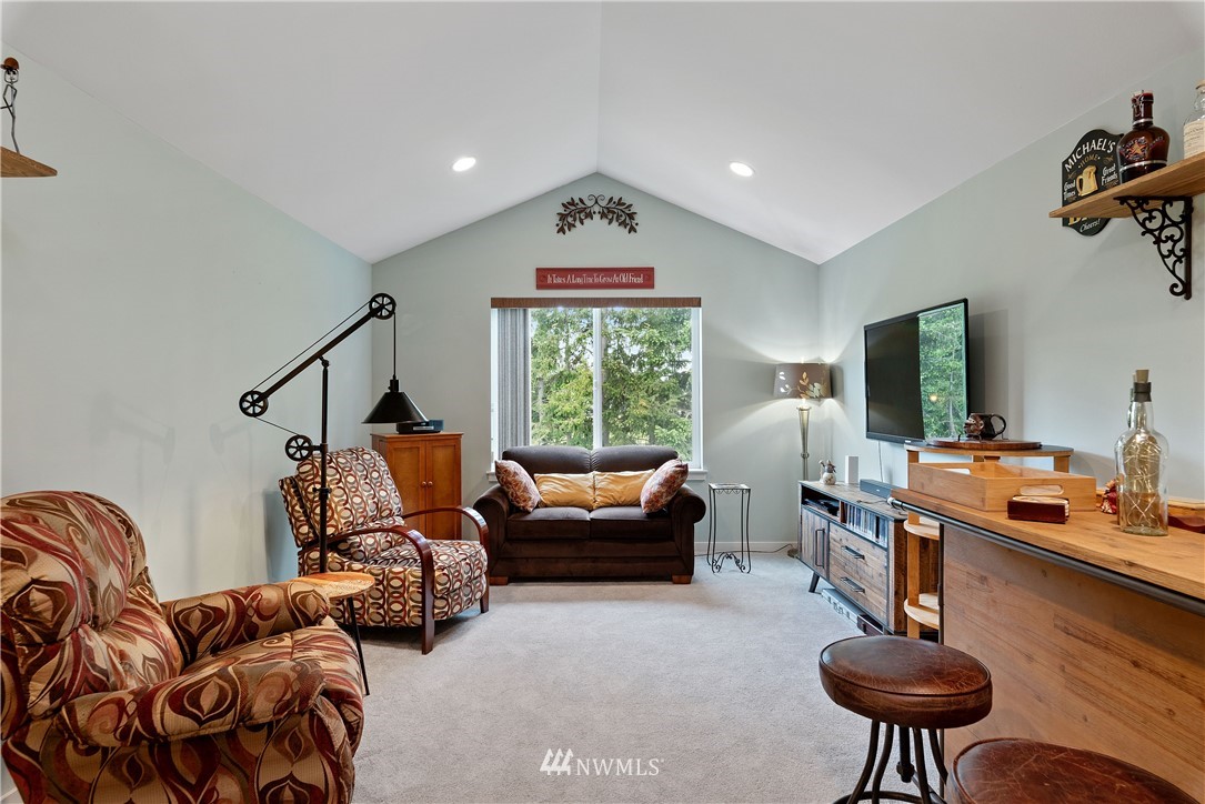 320 Blue Glacier Loop Sequim, WA 98382 - Photo 23 of 38 a living room with furniture a window and a flat screen tv