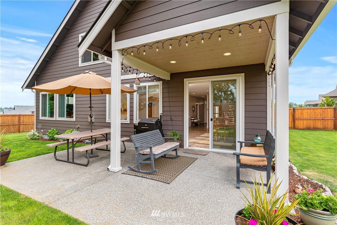 320 Blue Glacier Loop Sequim, WA 98382 - Photo 30 of 38 a patio with a table and chairs and potted plants