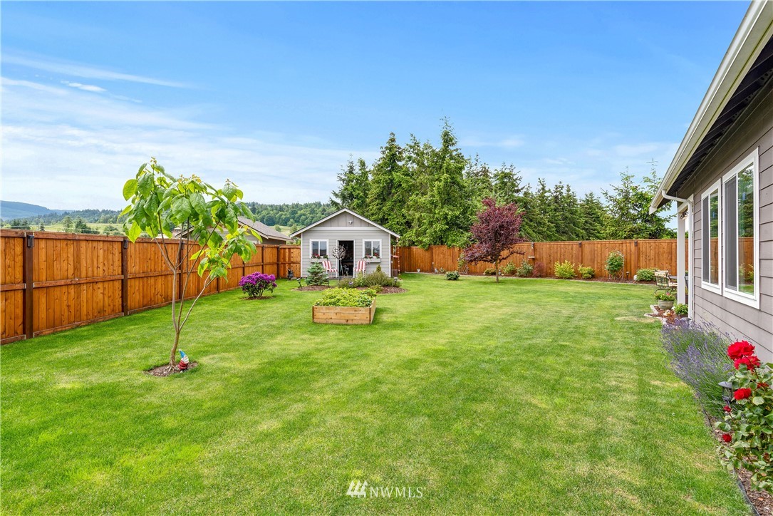 320 Blue Glacier Loop Sequim, WA 98382 - Photo 32 of 38 a view of yard with small cabin and wooden fence