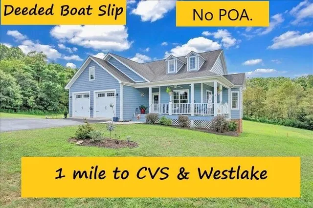 a kitchen with stainless steel appliances granite countertop a stove top oven a sink dishwasher and white cabinets with wooden floor