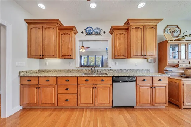 a spacious bathroom with a granite countertop tub sink and mirror