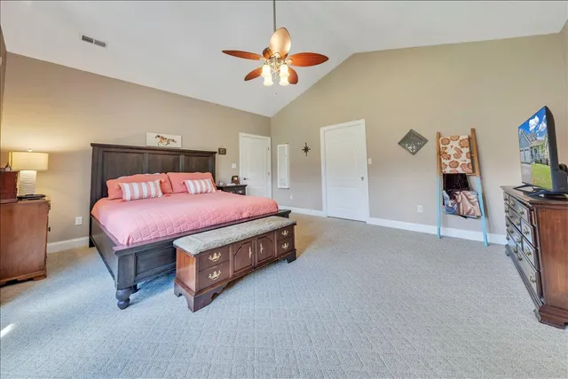a view of a house with a big yard potted plants and large tree
