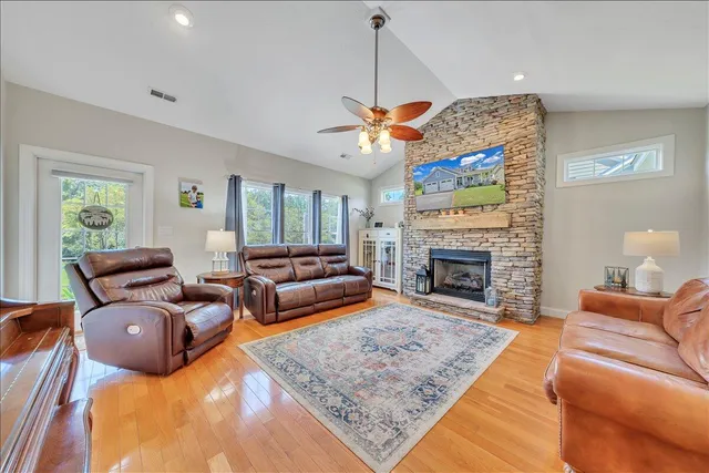 a living room with furniture a fireplace and a chandelier