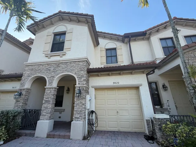 a front view of a house with garage