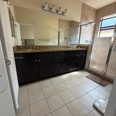 a bathroom with a sink vanity and mirror