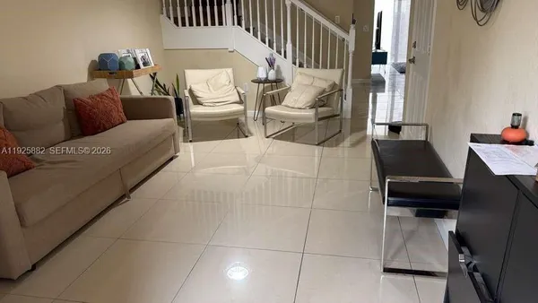 a living room with furniture and a flat screen tv