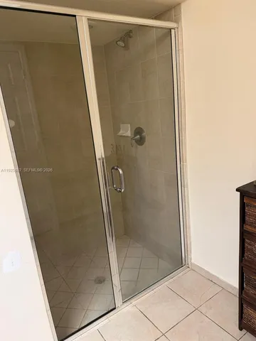 a bathroom with a glass door shower