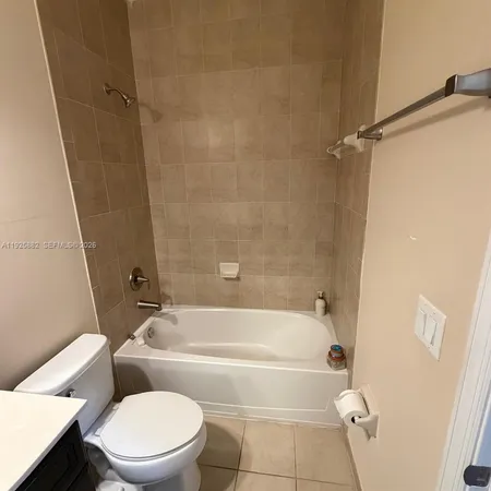 a bathroom with a toilet and a bath tub