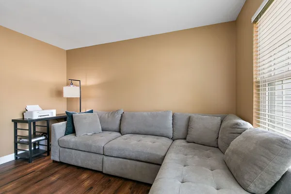 a living room with furniture and wooden floor