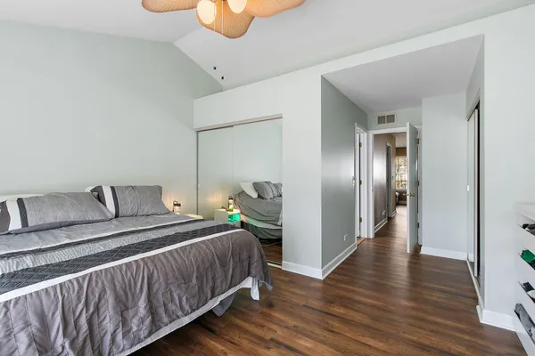 a bedroom with a bed and wooden floor