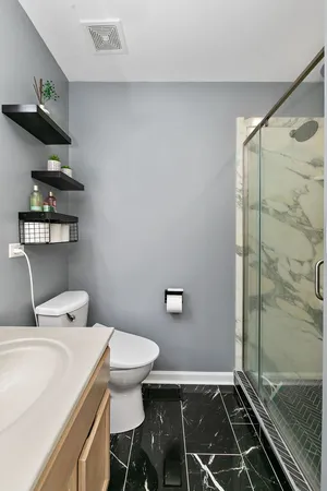 a bathroom with a toilet and a shower