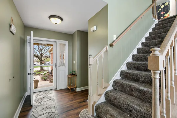 a view of entryway and hall with wooden floor