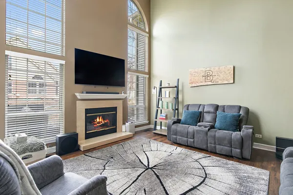 a living room with furniture a flat screen tv and a fireplace