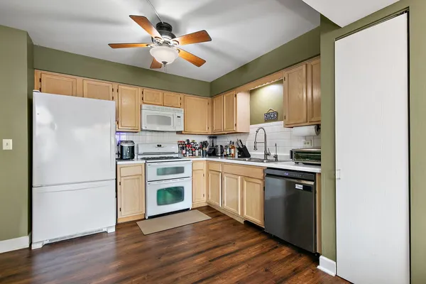 a kitchen with cabinets stainless steel appliances a sink and a window
