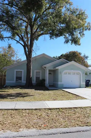 a house that has a tree in front of it