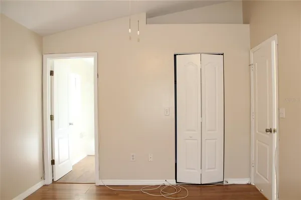 a view of a room with wooden floor