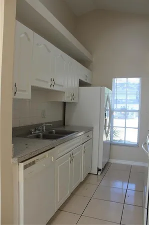 a kitchen with stainless steel appliances granite countertop a sink and a stove