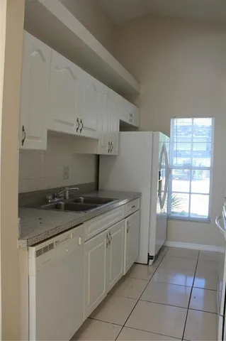 a kitchen with stainless steel appliances granite countertop a sink and a stove