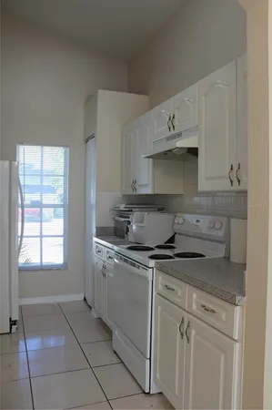 a kitchen with stainless steel appliances granite countertop a sink and a stove
