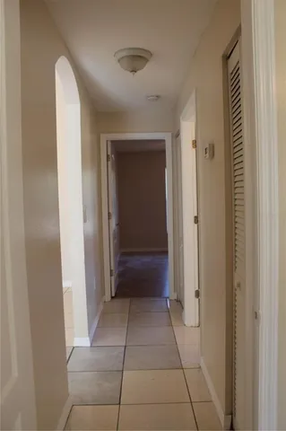 a view of a hallway to rooms