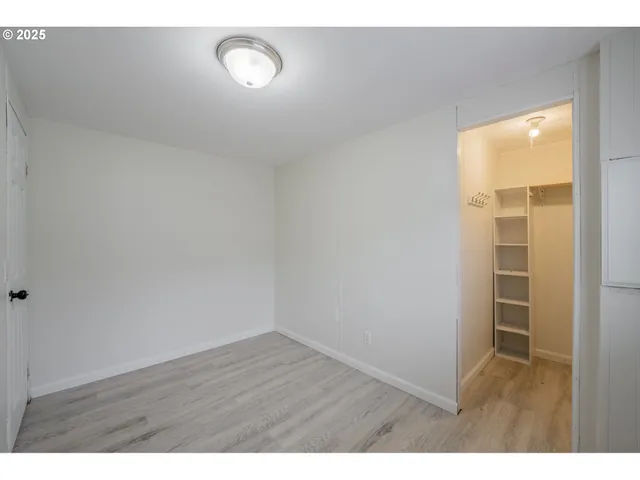 a view of an empty room and wooden floor