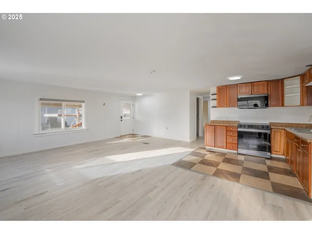 a view of a kitchen with a sink cabinets and a fireplace