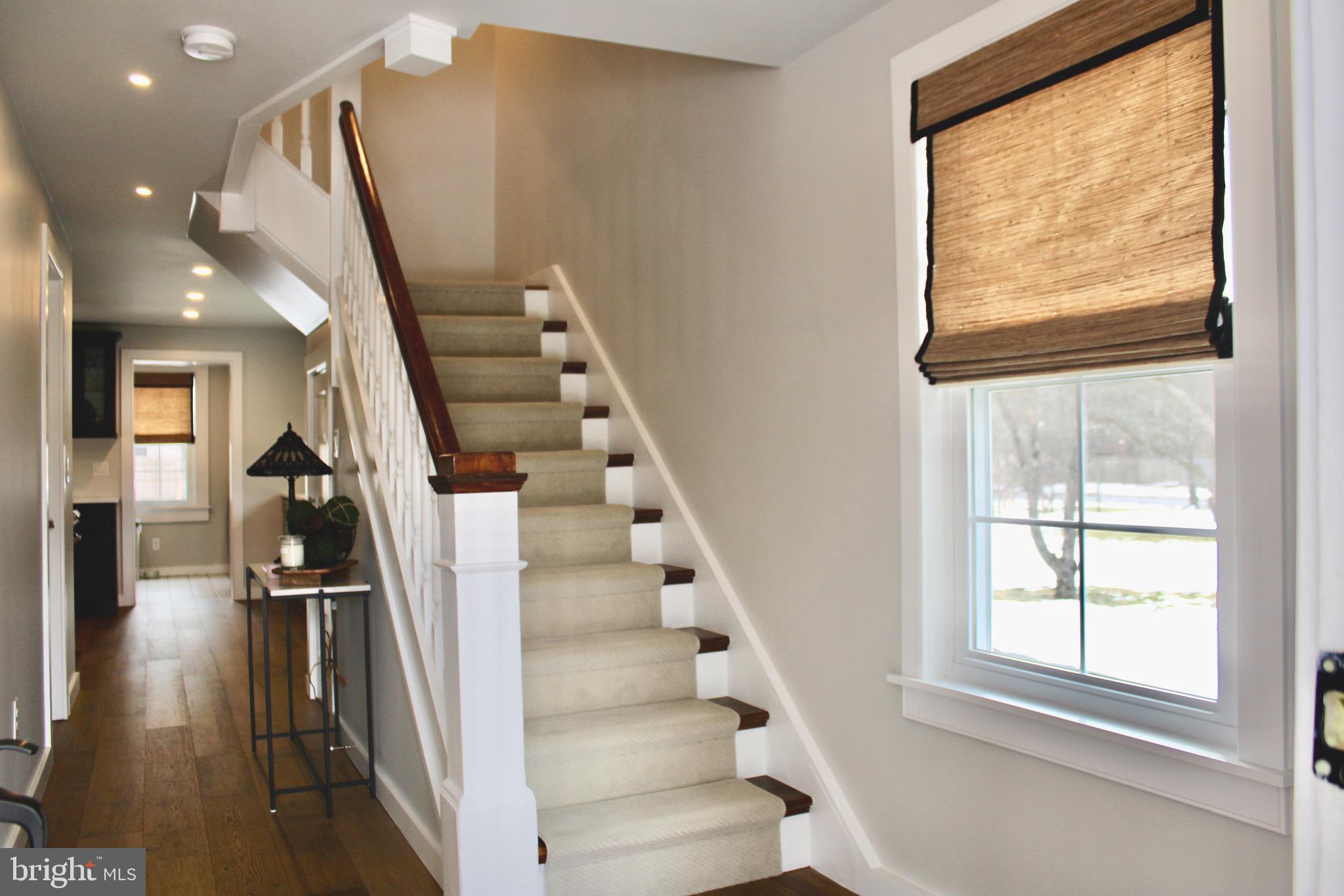 37 Cherry Lane Doylestown, PA 18901 - Photo 16 of 75 a view of staircase with lots of frames on wall and windows