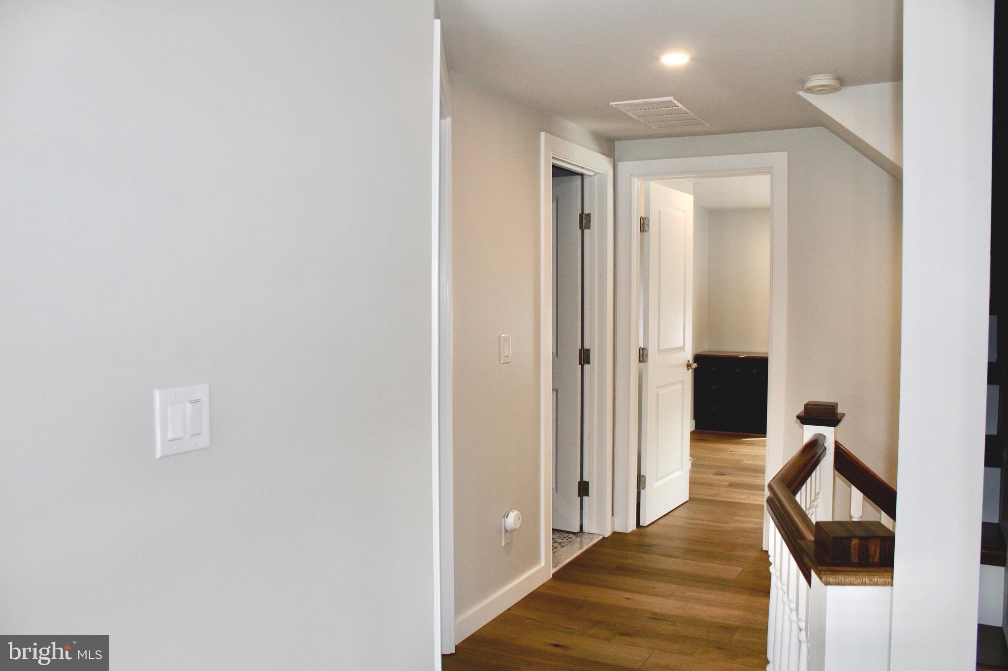 37 Cherry Lane Doylestown, PA 18901 - Photo 57 of 75 a view of a hallway with wooden floor and staircase
