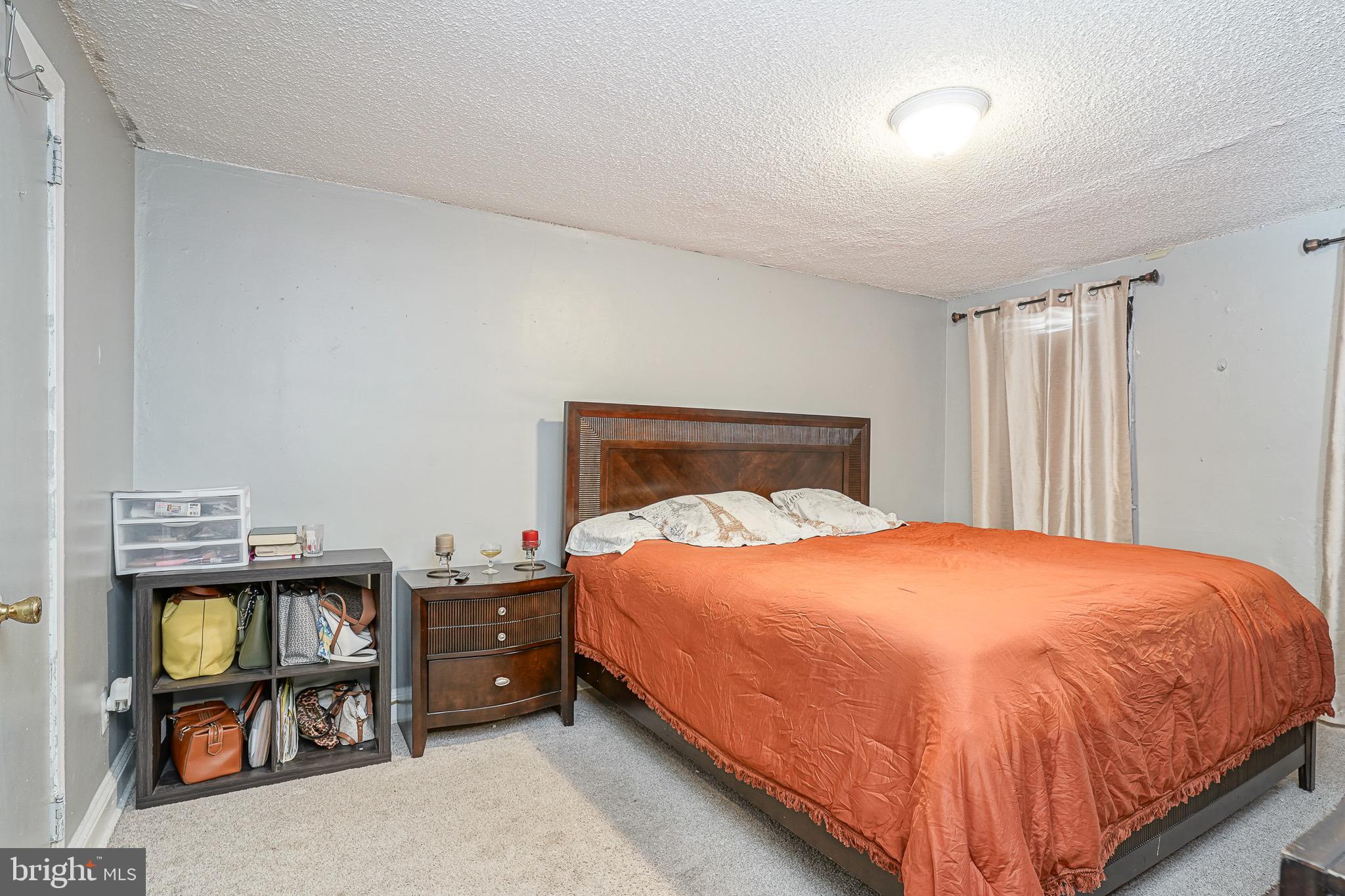 541 Randolph Street Camden, NJ 08105 - Photo 12 of 22 a bedroom with a bed and a flat tv screen on the dresser