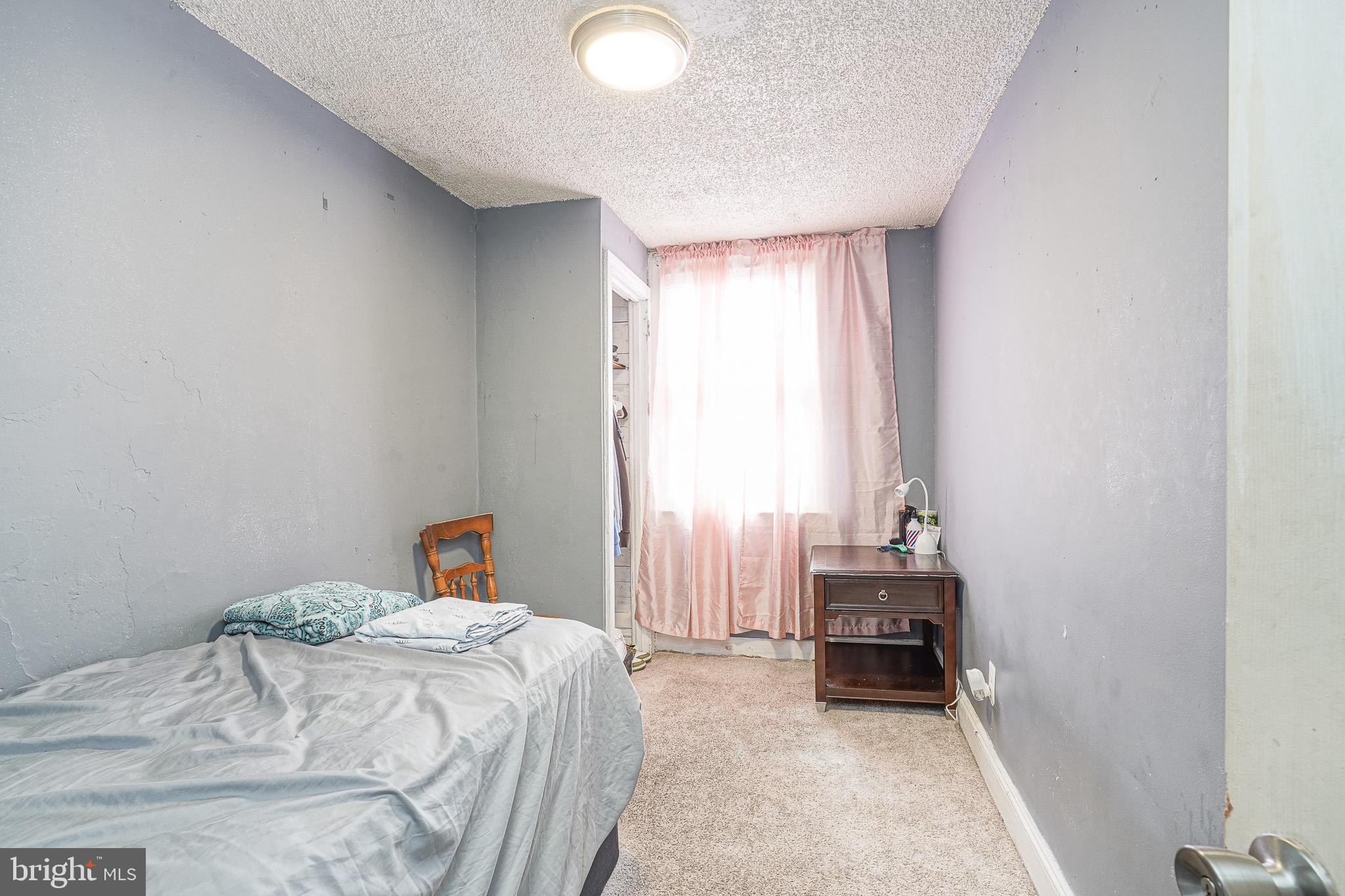 541 Randolph Street Camden, NJ 08105 - Photo 16 of 22 a bedroom with a bed and a window