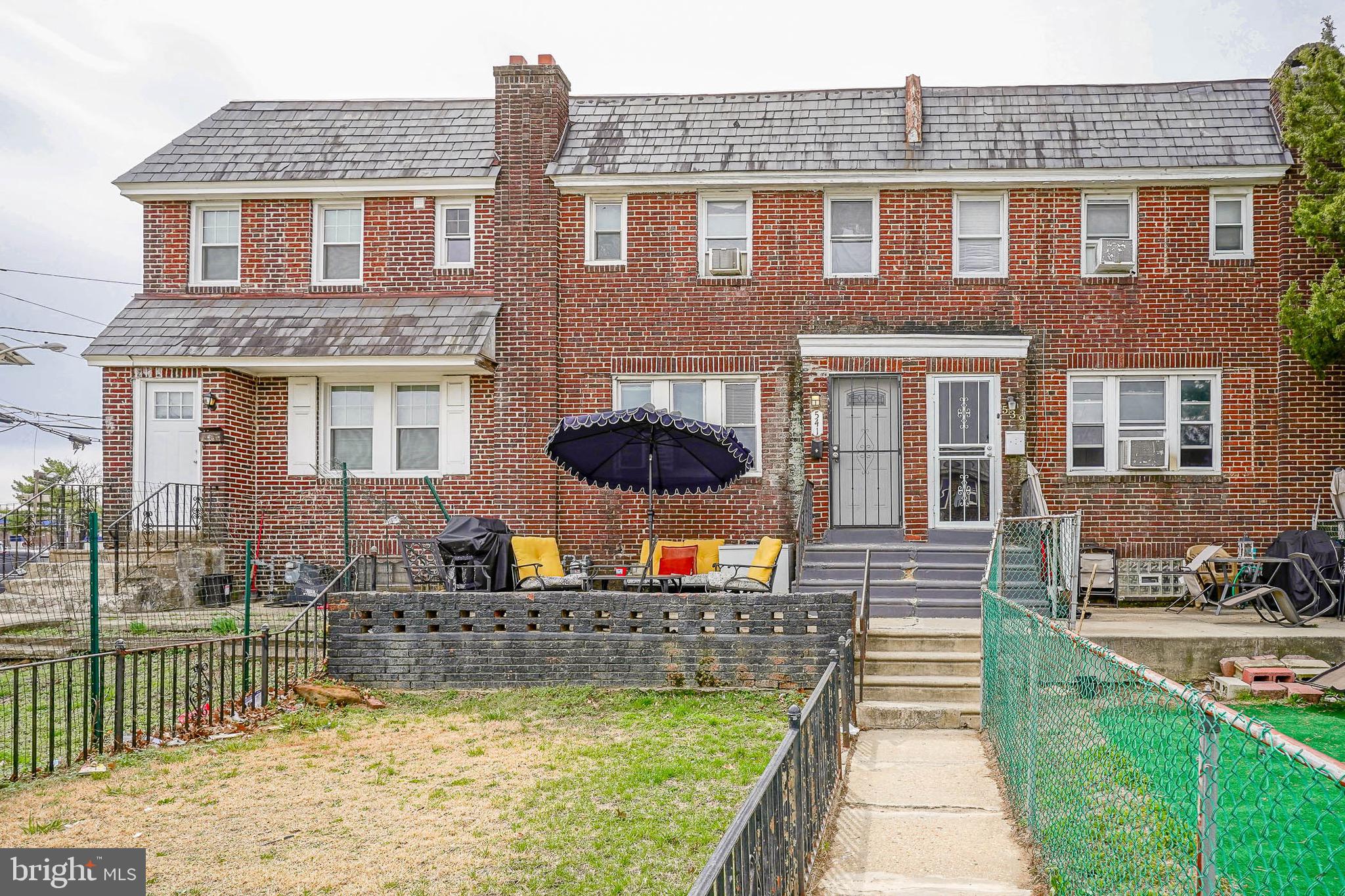 541 Randolph Street Camden, NJ 08105 - Photo 2 of 22 a front view of a house with a yard table and chairs