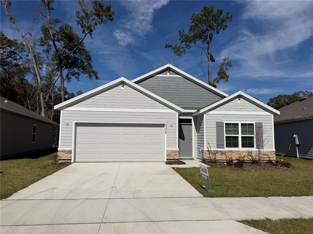 5326 Southwest 52nd Avenue Gainesville, FL 32608 - Photo 1 of 10 a front view of a house with a yard and garage