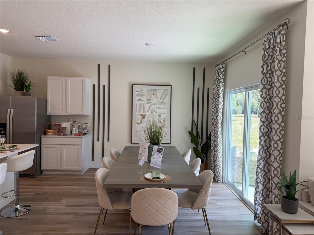 5326 Southwest 52nd Avenue Gainesville, FL 32608 - Photo 4 of 10 a dining room with furniture window and wooden floor