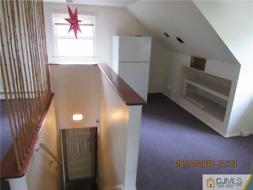 21 Halstead Road New Brunswick, NJ 08901 - Photo 12 of 22 a view of an empty room with window and stairs