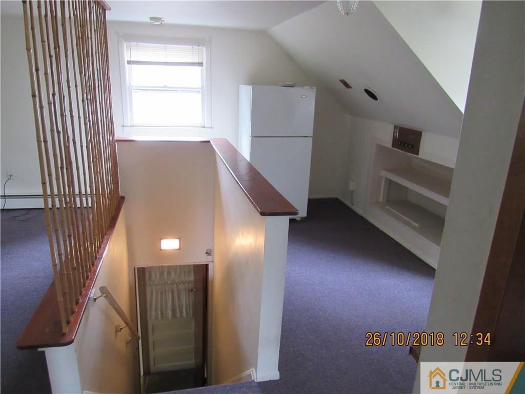 21 Halstead Road New Brunswick, NJ 08901 - Photo 15 of 22 a view of hallway with stairs and wooden floor