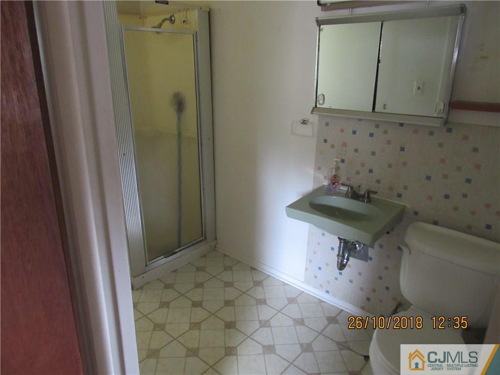 21 Halstead Road New Brunswick, NJ 08901 - Photo 16 of 22 a bathroom with a sink and a mirror