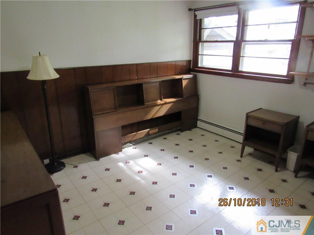 21 Halstead Road New Brunswick, NJ 08901 - Photo 5 of 22 a bedroom with a bed and a window