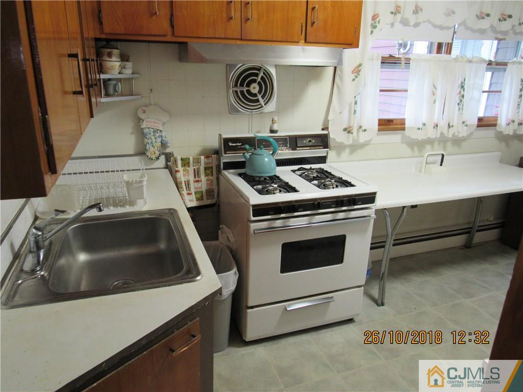 21 Halstead Road New Brunswick, NJ 08901 - Photo 8 of 22 a utility room with a stove a washer and dryer