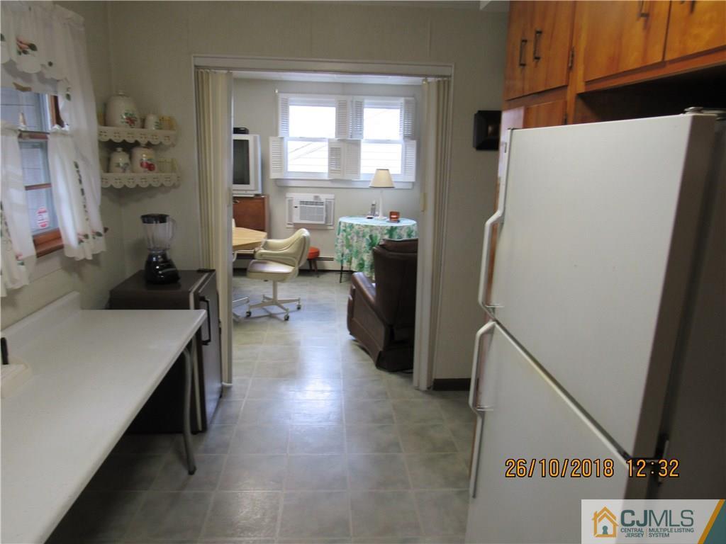 21 Halstead Road New Brunswick, NJ 08901 - Photo 9 of 22 a kitchen with a refrigerator a sink and cabinets