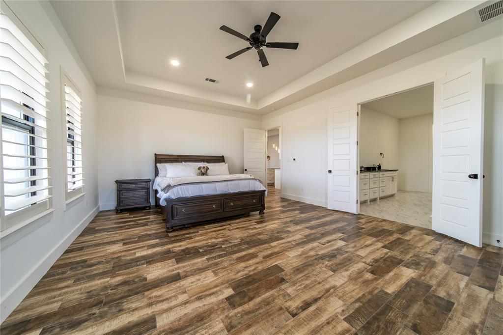 165 Ranch House Road Rockwall, TX 75032 - Photo 26 of 40 a spacious bedroom with a bed and a large window