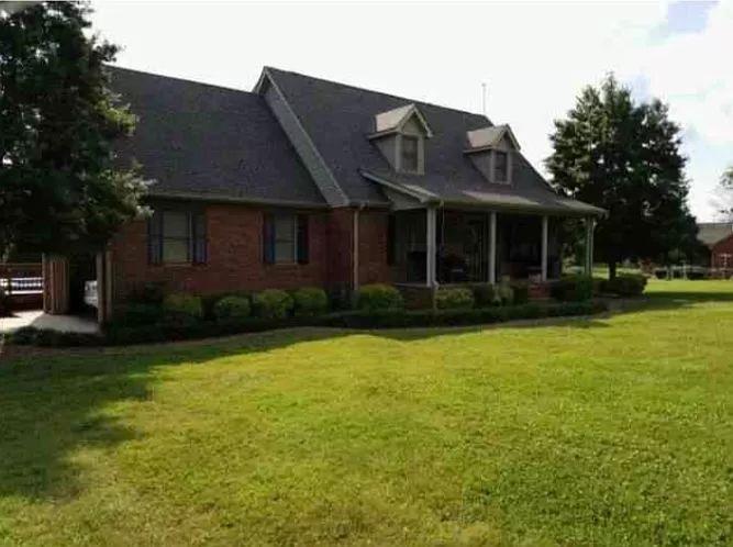 1701 Carter Road Decherd, TN 37324 - Photo 2 of 25 Large rocking chair front porch and gorgeous landscaping surrounds the house.