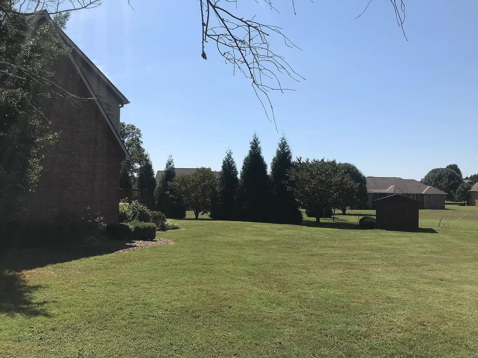 1701 Carter Road Decherd, TN 37324 - Photo 23 of 25 Now lets head around back and take a look. Large trees in back for privacy. There is a storage building too.