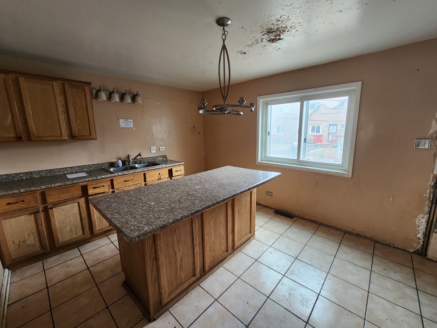 2211 171st Street Hazel Crest, IL 60429 - Photo 3 of 12 a kitchen with stainless steel appliances granite countertop a sink dishwasher a stove a refrigerator and a dining table with wooden floor