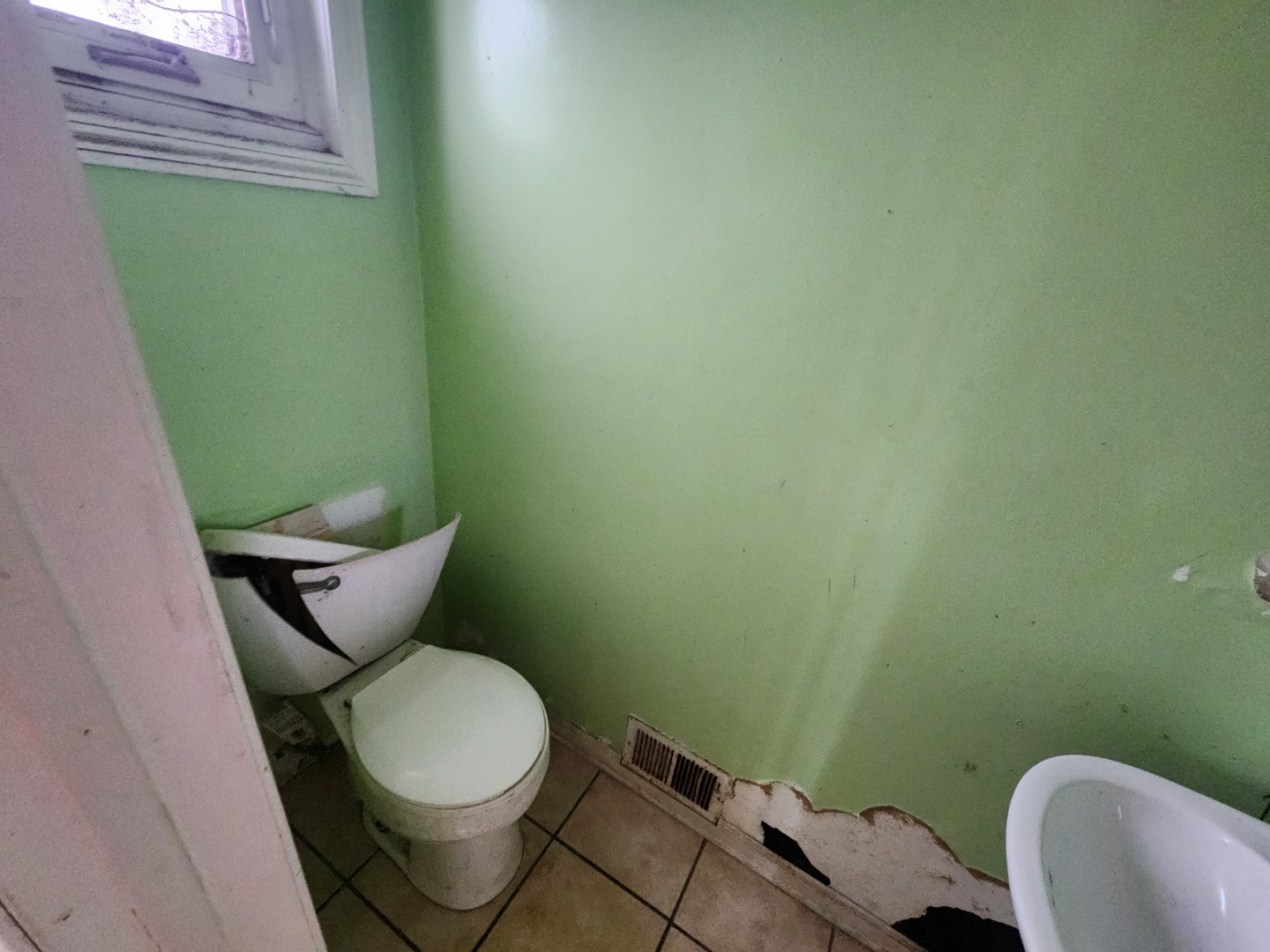 2211 171st Street Hazel Crest, IL 60429 - Photo 4 of 12 a toilet sitting in a bathroom next to a sink