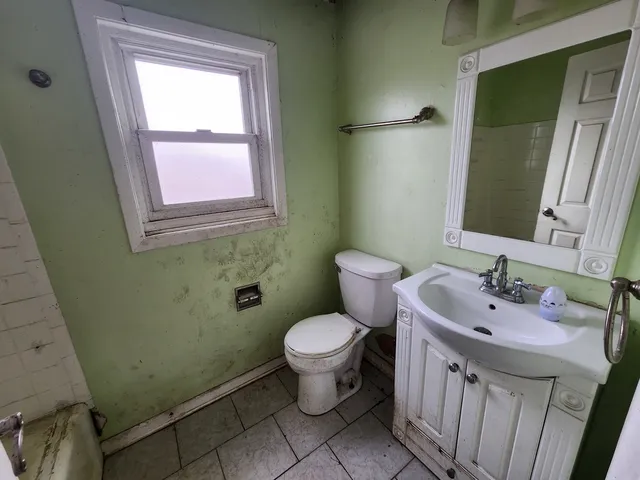 a bathroom with a sink toilet and a mirror