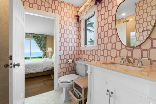 a bathroom with a sink a toilet and a mirror
