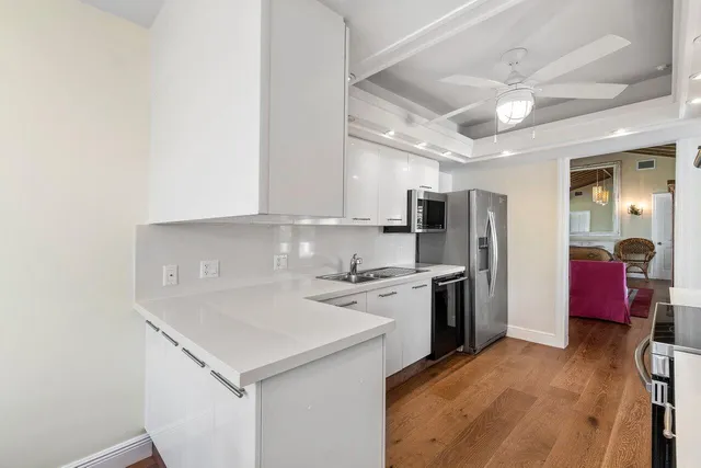 a kitchen with stainless steel appliances a sink stove and refrigerator